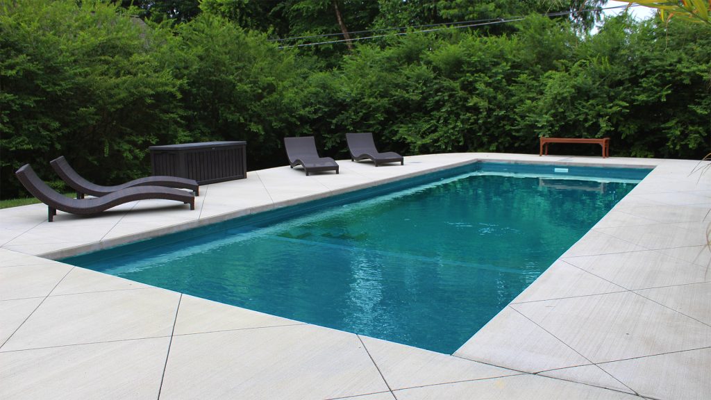 The Freedom with Splash Pad fiberglass pool by Imagine Pools.