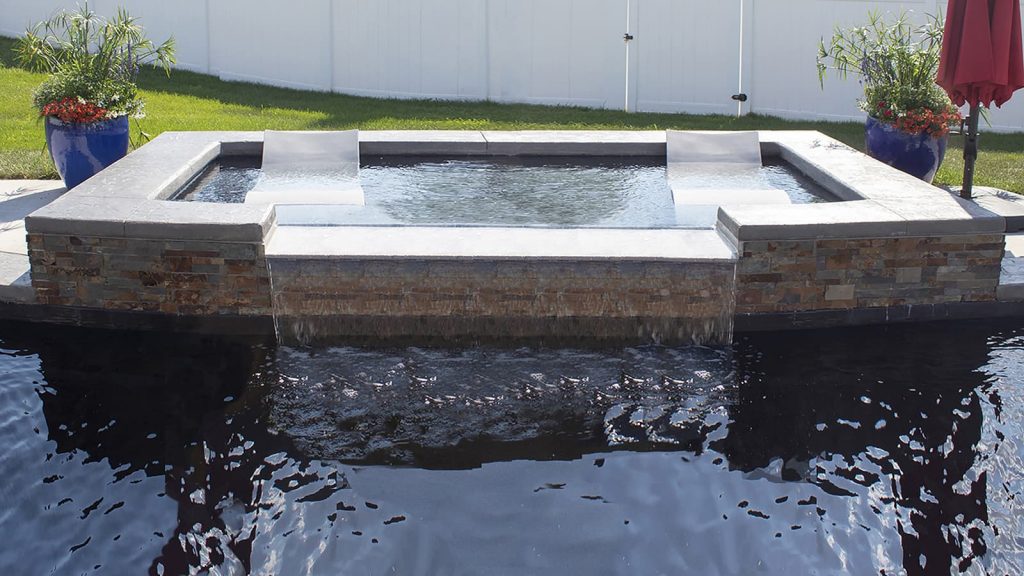 Lagoon tanning ledge with spillover into pool