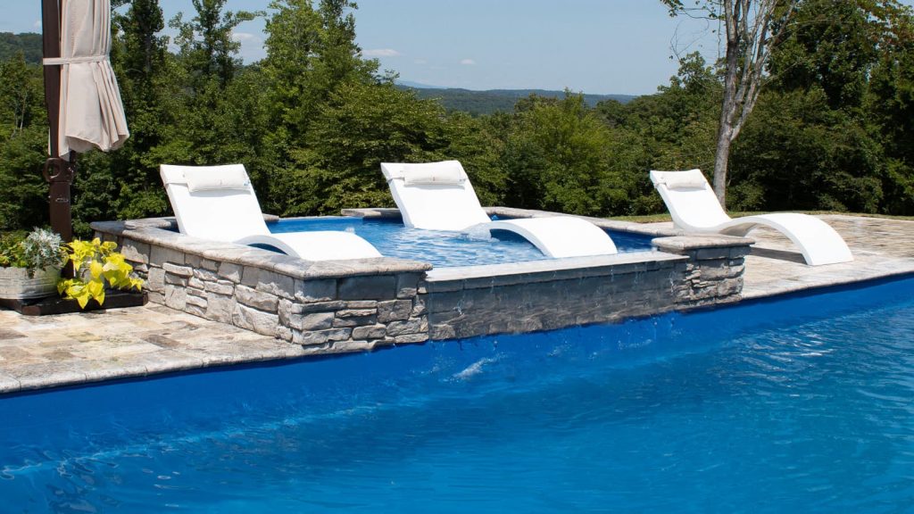 Lounge chairs in the Lagoon fiberglass Tanning Ledge from Imagine Pools.