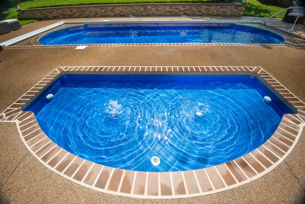 Wet Deck Fiberglass Pool next to another pool by Thursday Pools.